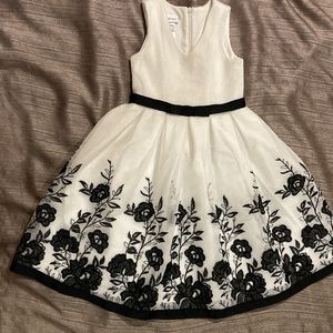 Bonnie Jean. girl's dress color white with black flowers. Size 7